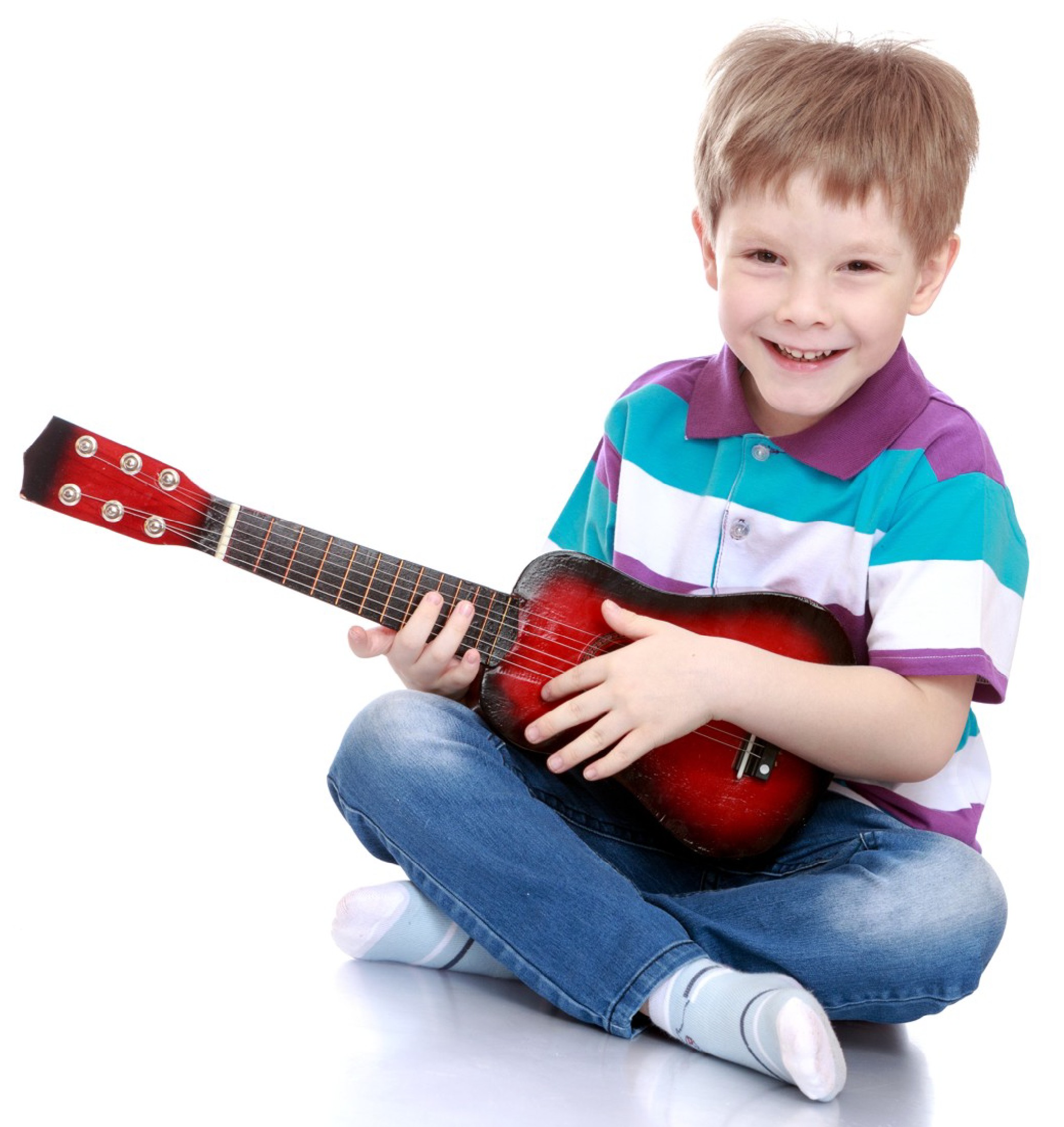 Half size guitar. Small boy learning to play a half size acoustic guitar