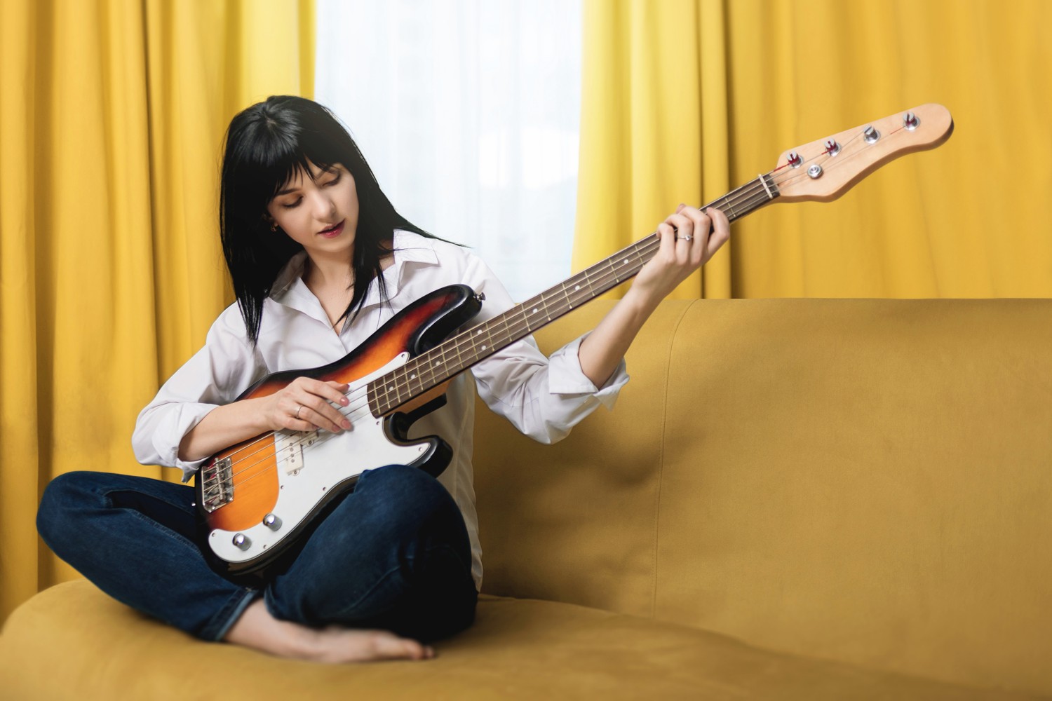 Woman Practising on Bass Guitar