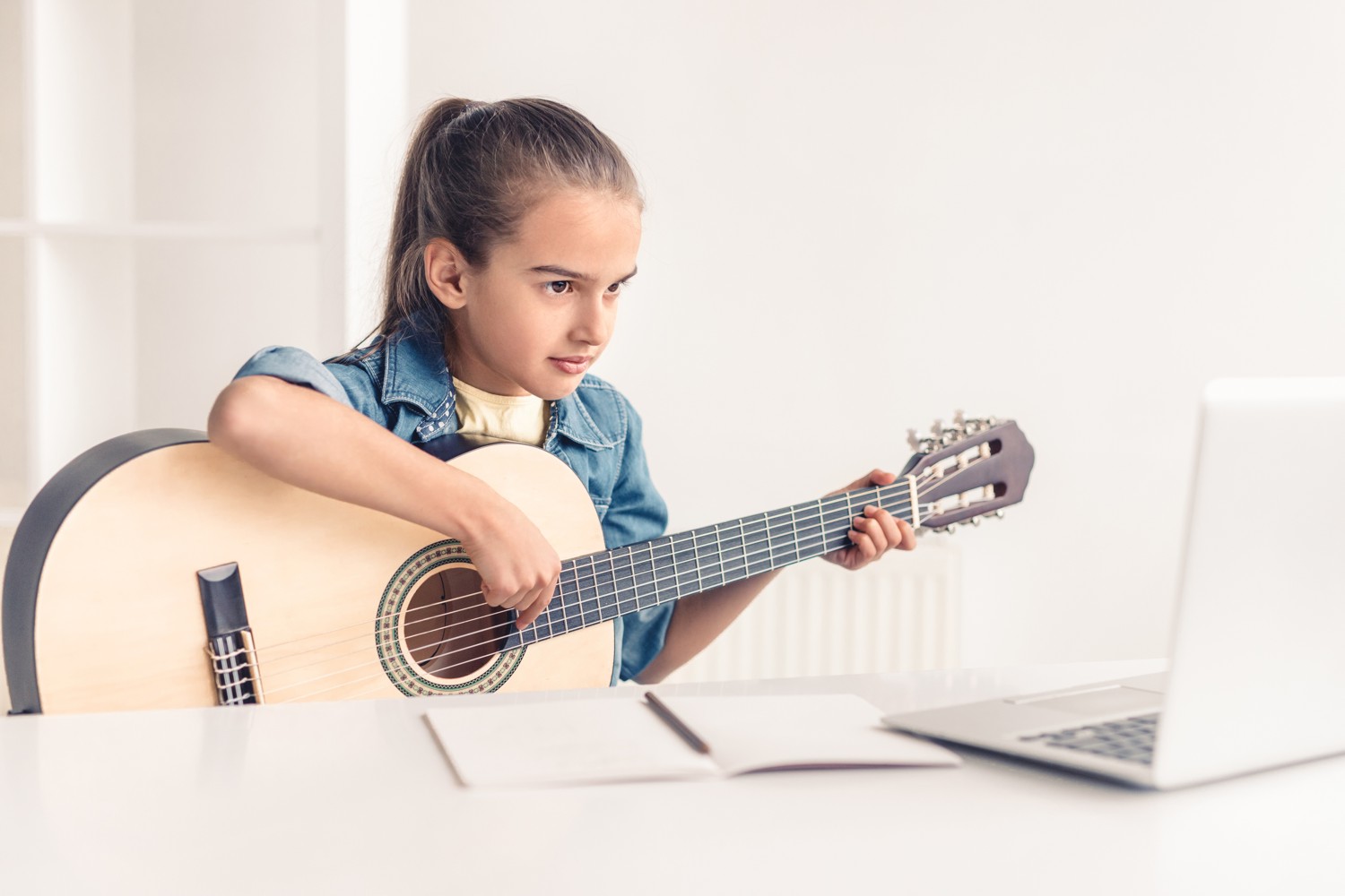 Little Girl Learning to Play the Acoustic Guitar